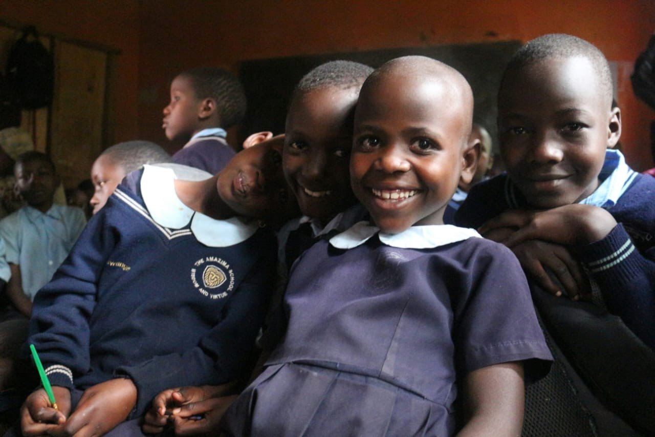 Schoolchildren in uniform smiling together in class